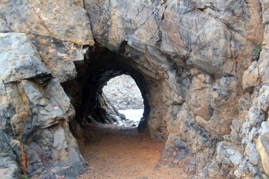 A tunnel between beaches at Cala Domestica. 