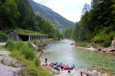 Lots of canoeists rafting down the Enns River. 